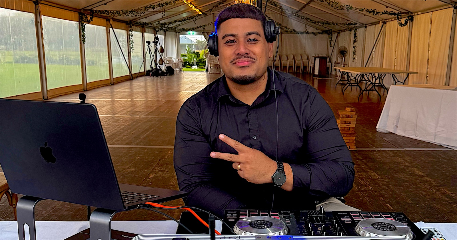 DJ Songz at the decks in a wedding marquee
