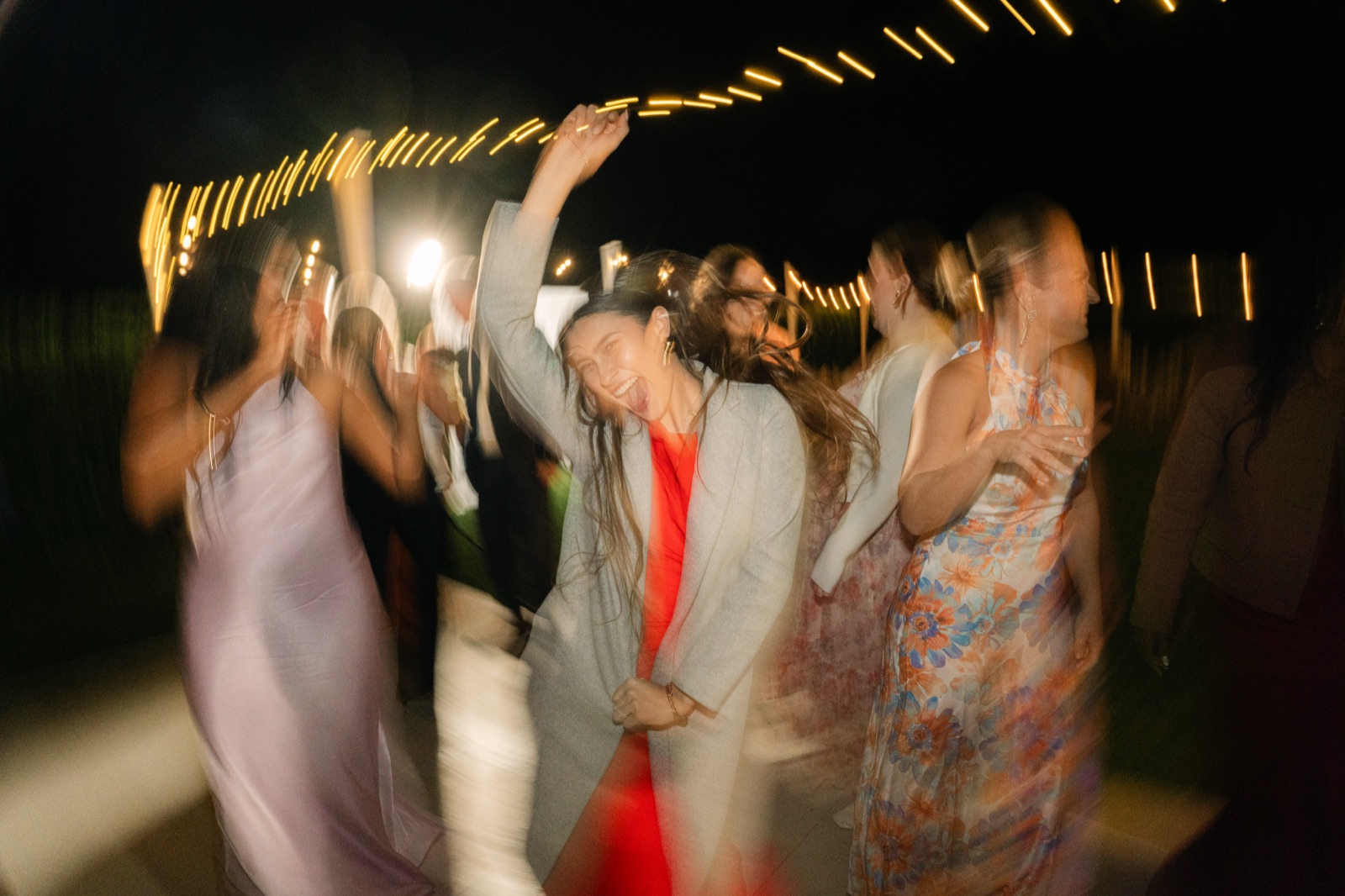 Guests dancing with hands raised