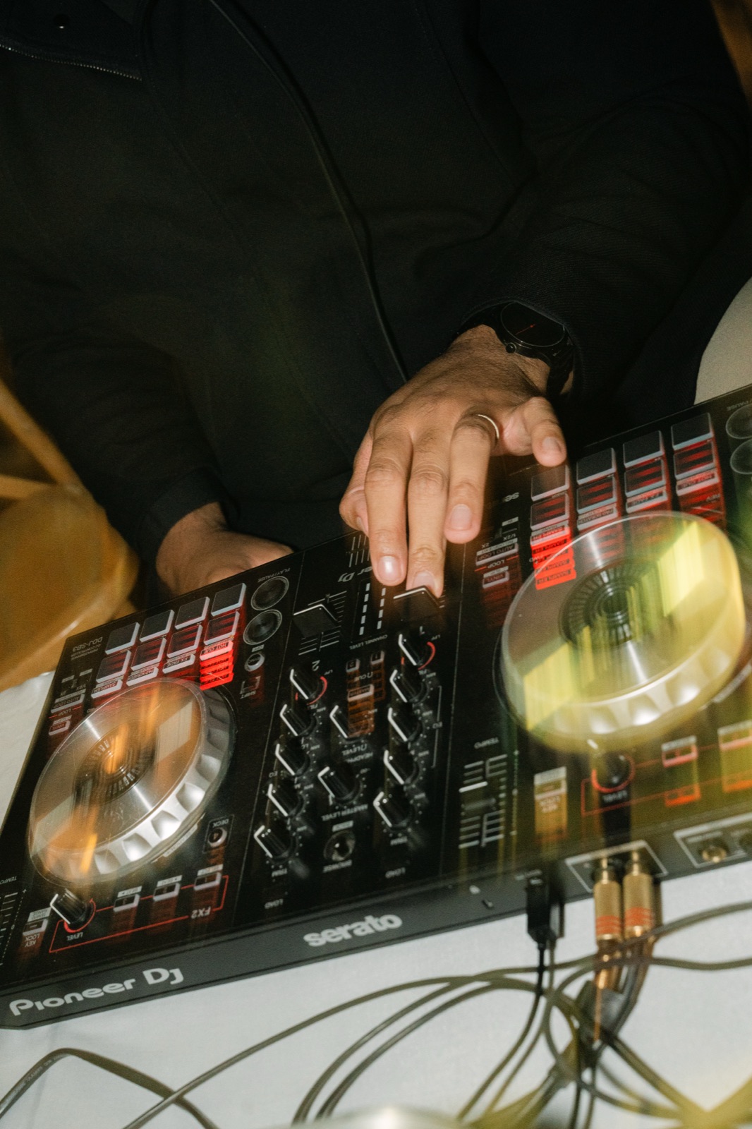 Hands on the DJ controller mid-mix